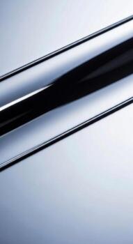 Close up abstract view of a polished metallic surface with subtle reflections and a cool blue gradient background photo