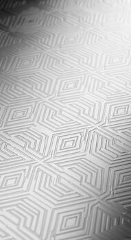 Abstract geometric pattern with a subtle metallic sheen creating a textured and visually engaging background photo