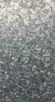 Abstract camouflage pattern with a gradient of light green to dark gray featuring small irregular shapes photo