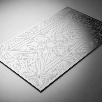 Intricate geometric pattern etched onto a metallic surface creating a textured and reflective abstract background photo