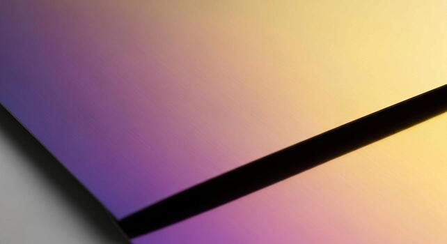 Abstract geometric composition featuring a gradient of purple to yellow hues intersected by a sharp black line photo