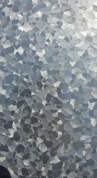 Abstract pattern of textured frosted glass with subtle hints of green and gray tones creating a diffused light effect photo