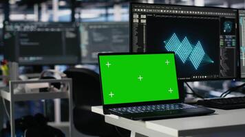 Engineer in data center coding with assistance on chroma key laptop. Computer scientist leveraging artificial intelligence large language model on isolated screen notebook, camera A video