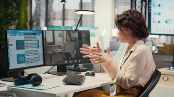 Businesswoman participates at web chat event with a shareholder, sharing insight on performance metrics for a briefing. conferencing in the office between business associates. Camera B. video