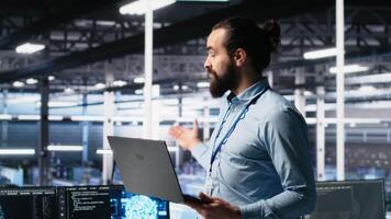 Data center manager showcasing AI technology, filming presentation for audiences. Server farm team leader presenting artificial intelligence machine learning tech, camera A video