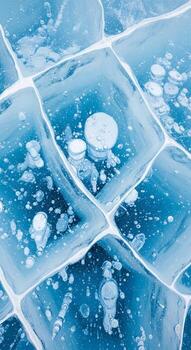 Intricate geometric patterns formed by frozen bubbles trapped within a crystal clear icy surface creating a mesmerizing natural mosaic photo
