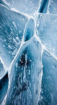 Close up abstract view of fractured ice formations with intricate patterns and trapped air bubbles creating a cool blue texture photo