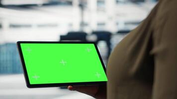 Server room admin uses isolated screen tablet to increase supercomputers workload capacity. Data center worker configures gear with chroma key device notebook, improving processing speed, camera B video