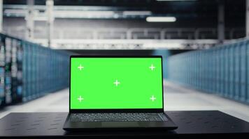 Close up of green screen laptop in data center used for checking hardware for system stability. Mockup notebook used to oversee server farm and configure infrastructure for optimum performance video