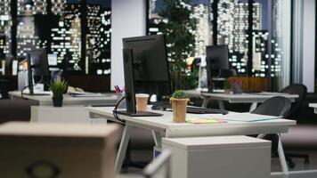 Empty dark office features high tech gadgets and dual monitors, analytics tools ready for business strategy and report writing to support professional growth and organizational success. video