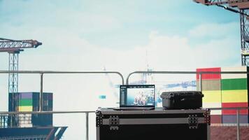 Laptop on drilling rig ship with dashboard monitoring operation performance. Notebook on offshore platform deck with application used to control systems remotely, panning shot video