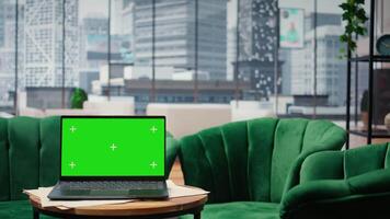 tömma global företag kontor visa upp en grön skärm på bärbar dator, modern arbetsyta utrustad med professionell gadgetar och nätverkande systemet. karriär utveckling och motivering. video