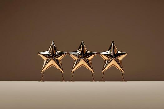 Three Shiny Gold Stars on a Smooth Surface Against a Soft Brown Backdrop photo
