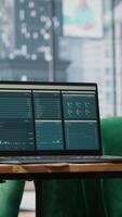 Vertical Big data reports and graphics showcasing business corporation success, empty luxurious office with a laptop on the table. Professional workspace with pc display running trends. video
