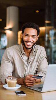 Man Smiling While Working on Laptop in a Cozy Cafe During the Afternoon photo