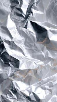 Reflective Surface of Crumpled Aluminum Foil With Shadows photo
