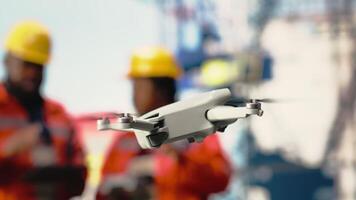Close up of drone used by operators working on offshore platform, doing site inspection. Engineers use aerial photography technology to determine optimal locations for drilling pipelines, camera B video