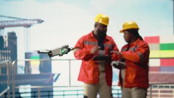 Close up of drone used by operators working on offshore platform, doing site inspection. Engineers use aerial photography technology to determine optimal locations for drilling pipelines, camera A video