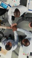 vertical topo baixa Visão ampliação Fora do companhia empregados unindo mãos e torcendo seus grupo sucesso, projeto planejamento e dados análise. colegas foco em recurso alocação para alcançar progresso. Câmera uma. video
