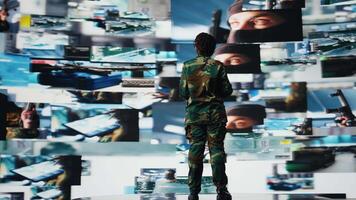 Soldier in command post providing combat support, projecting reconnaissance feeds on videowall with laptop. Intelligence agency specialist uses battlefield communication network on notebook, camera A video