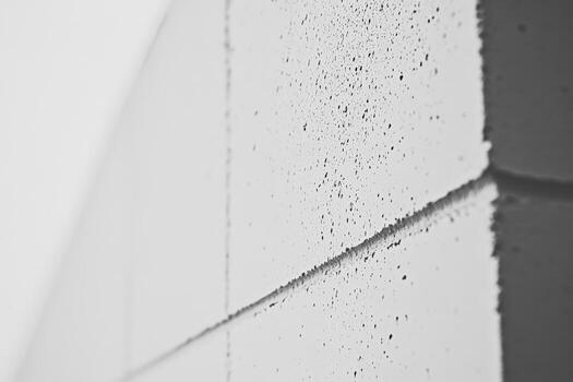 Grey textured wall with visible mortar joints and speckles photo