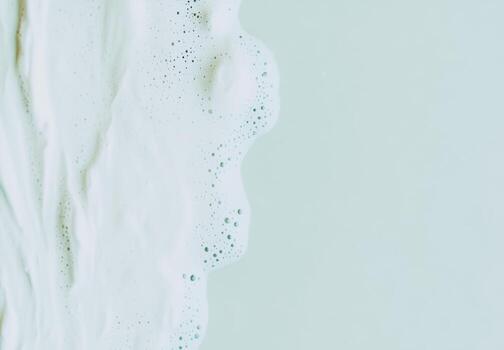 Creamy foam on a textured surface in soft colors photo