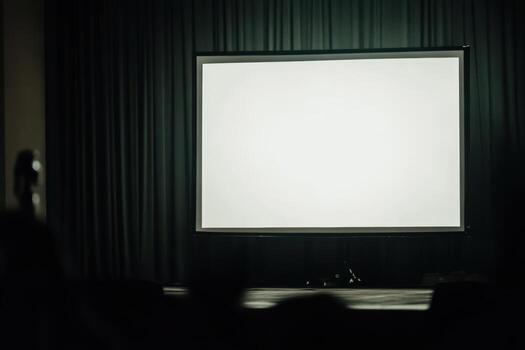 Empty stage with a large screen in a darkened theater photo