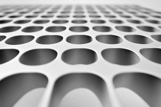 Close-up view of a metal grid with circular openings photo