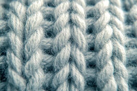 Soft gray yarn texture revealing intricate knitting patterns photo