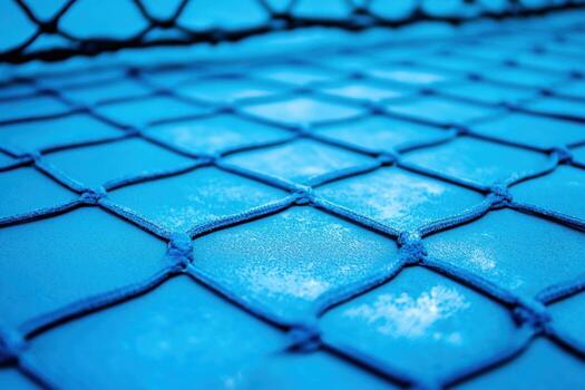 Blue netting over a vibrant surface in a sports area photo