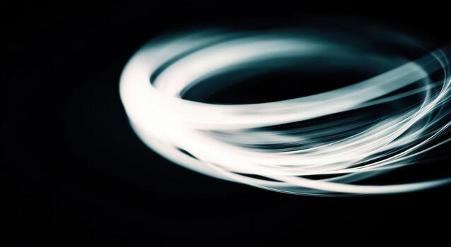 Light trails create abstract shapes in a dark space photo