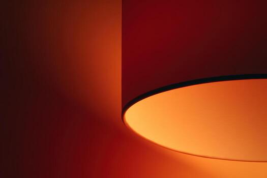 Warm glow from a modern lampshade in a dark room photo