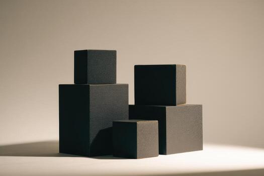 Stacked black blocks in a soft-lit studio setting photo