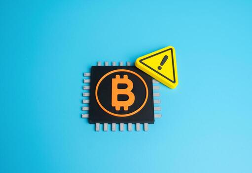 Bitcoin chip and warning sign. Cryptocurrency mining issues. Spam attacks on the Bitcoin network. Concept of cybersecurity, data protection, blockchain vulnerability, and digital economy risks. photo