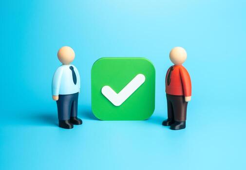 Two office workers near a huge checkbox. Agreement and consent. Conclude a contract. Collaboration, corporate responsibility, and digital confirmation processes in business management. photo