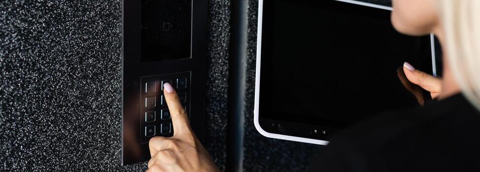 Secure Home System, Hand Pressing on Intercom Keypad, Using Door Phone, Doorphone, Entryphone, Videophone Call, Digital Electronic Doorbell photo