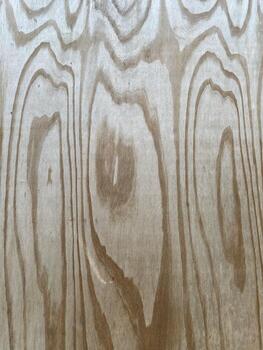 Surface of a natural wooden board with dark elongated growth rings. The warm wood tones, organic grain patterns create an authentic surface for use as wood texture, rustic background, organic backdrop photo