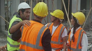 Team group contractor and architect with foreman explaining about scheme building site for planning project to worker and looking blueprint, construction site, development and structure. video