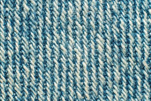 Detail macro view of light blue denim with visible fibres and diagonal weave of threads photo