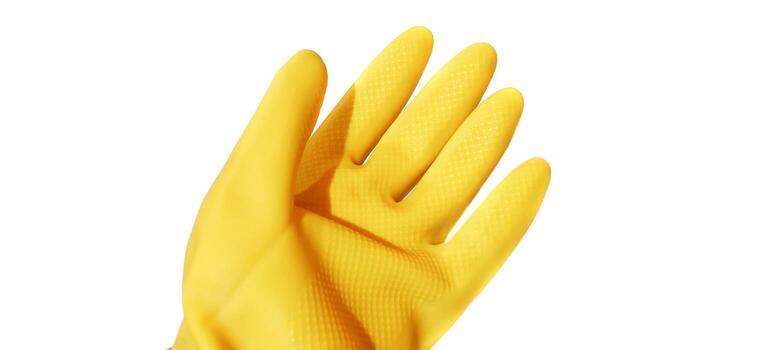 Close up hand gesture in yellow rubber glove showing five fingers, stop palm gesture isolated on a white background photo
