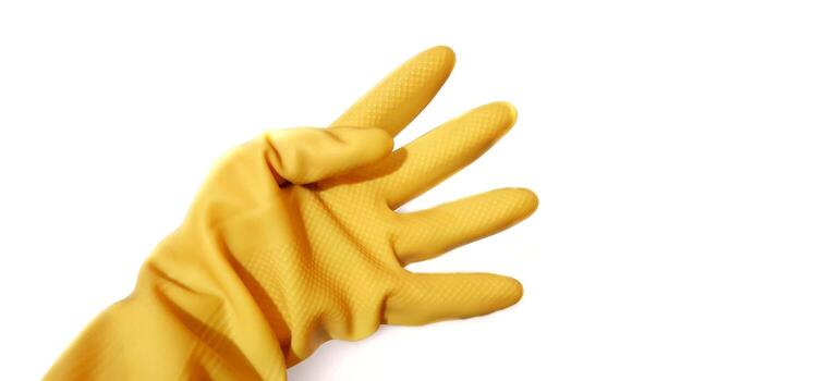 Hand gesture in yellow rubber glove showing four fingers, isolated on a white background with clipping path photo