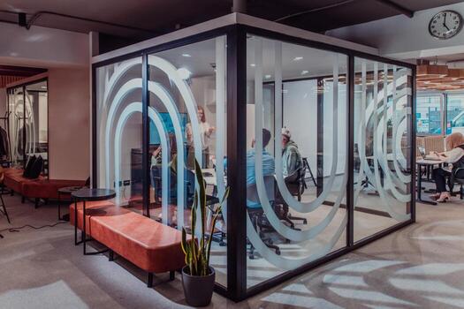 A group of young business entrepreneurs engages in a focused meeting, discussing various business strategies and collaboratively solving challenging problems, showcasing ambition, creativity, and photo