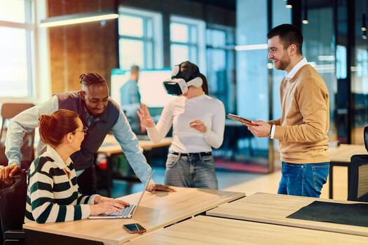 Group of creative professionals collaborating in a modern office using virtual reality headset and digital devices, representing innovation, teamwork, and futuristic workplace technology. photo