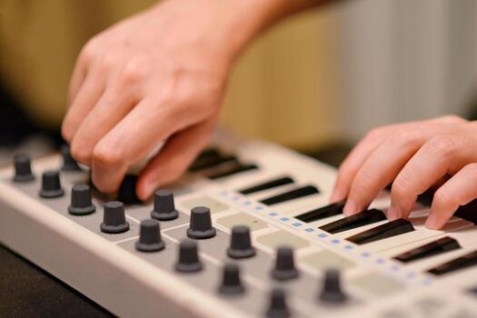 Man Playing Synthesizer Keyboard MIDI Controller. Hands close up. Electronic Music Production concept. photo