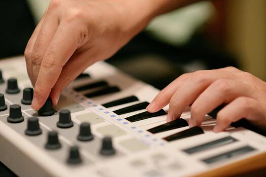 Man Playing Synthesizer Keyboard MIDI Controller. Hands close up. Electronic Music Production concept photo