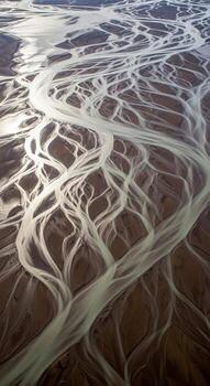 Aerial view of a braided river system with intricate channels and sediment deposits creating a natural abstract pattern on the landscape photo