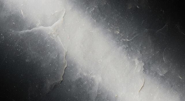 Abstract textured background with dramatic diagonal light beam and dark shadowy areas creating a moody atmosphere photo