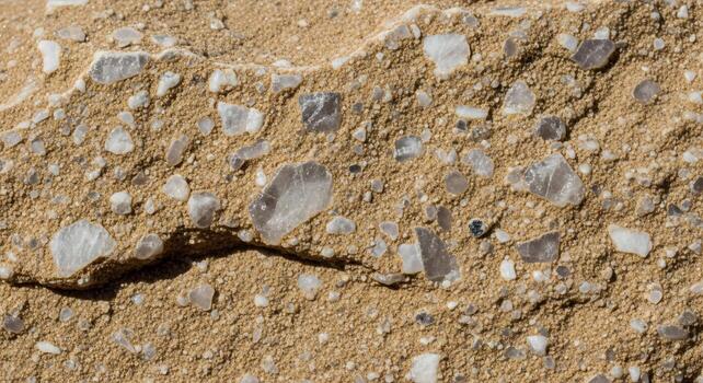 Close up view of a rough concrete surface embedded with colorful reflective and translucent aggregate stones photo