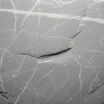 Close up macro view of a fractured gray stone surface revealing intricate natural patterns and subtle textures photo