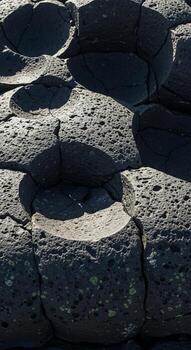Natural hexagonal basalt columns formed by volcanic activity creating a unique geological landscape photo